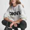 Sweter z długimi rękawami, miękkim materiałem typu scuba i logo